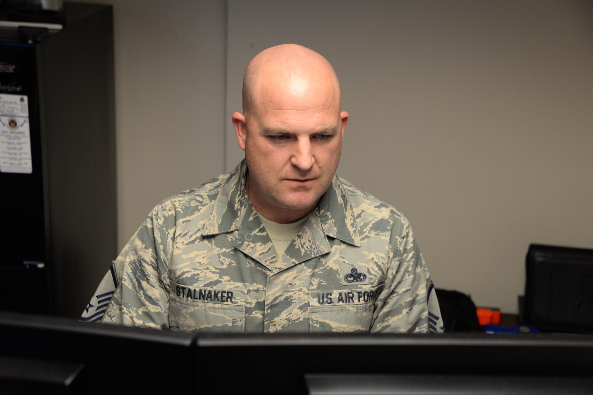 Master Sgt. James Stalnaker, 60th Maintenance Squadron, works at his desk at Travis Air Force Base, Calif., March 20, 2017. Stalnaker suffered a traumatic brain injury, broken ribs and several other injuries in a motorcycle crash in October 2015. He is now a master resiliency training instructor and shares his personal resilience story with Travis Airmen. (U.S. Air Force photo/Tech. Sgt. James Hodgman/Released)