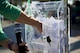 Lia Davis, a commercial sponsorship and advertising programs manager with the 1st Special Operations Force Support Squadron, reaches into a bin to draw a name at a raffle during the Lil' Commando Community Park reopening celebration at Hurlburt Field, Fla., March 17, 2017. The Lil' Commando Community Park reopened after renovations which included a new zip line, playground and splash pad. (U.S. Air Force photo by Airman 1st Class Dennis Spain)