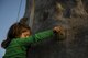 Elizabeth Waddell, daughter of Maj. John Waddell, an instructor pilot with the 19th Special Operations Squadron, climbs a rock wall at Hurlburt Field, Fla., March 17, 2017. During the Lil' Commando Community Park reopening celebration, attendees participated in festivities such as rock climbing, Segway rides and a bounce house. (U.S. Air Force photo by Airman 1st Class Dennis Spain)