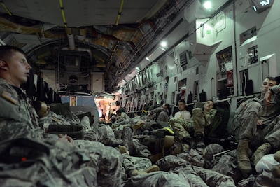 Paratroopers ride in a C-17 aircraft from Alaska to their jump site in Australia, a 17-hour flight that left many trying to get some pre-jump rest on the aircraft. The quality of soldiers' sleep has a direct bearing on readiness, an Army researcher said. Army photo by David Vergun