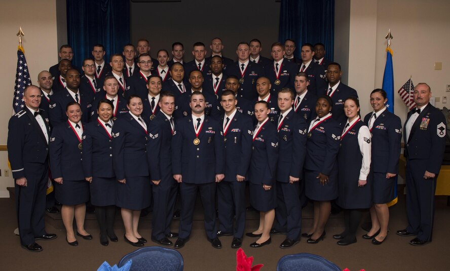 Col. Todd Sauls, 90th Operations Group commander and Chief Master Sgt. Kristian Farve, 90th Operations Group superintendent, poses with the graduating Airman Leadership School Class 17-D students at F.E. Warren Air Force Base, Wyo., March 22, 2017. Enlisted Airmen must complete the rigorous professional military education course to become supervisors of other Airmen. (U.S. Air Force photo by Staff Sgt. Christopher Ruano)