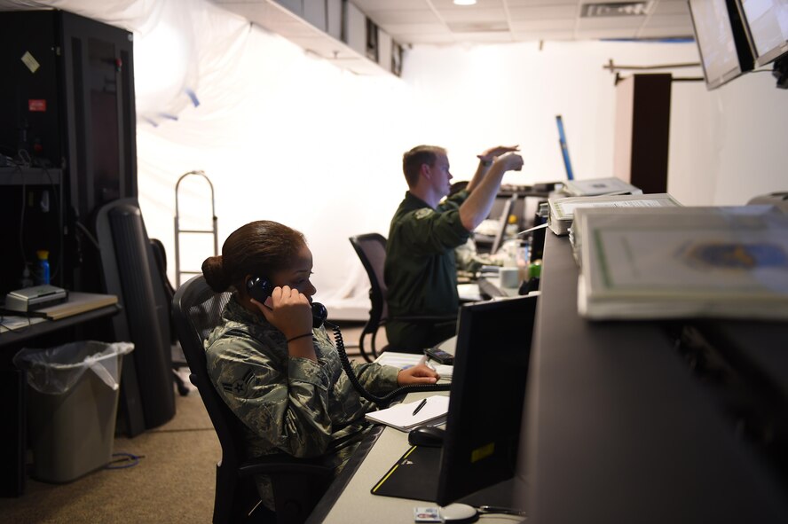 Airman 1st Class Dekenya Jackson, 62 AW Command Post controller, answers a call at the 62nd Airlift Wing command post on Joint Base Lewis-McChord, Wash., March 20, 2017. The command post is the hub for information being relayed on McChord Field, and has recently undergone major renovations. (Air Force photo/ Staff Sgt. Naomi Shipley)