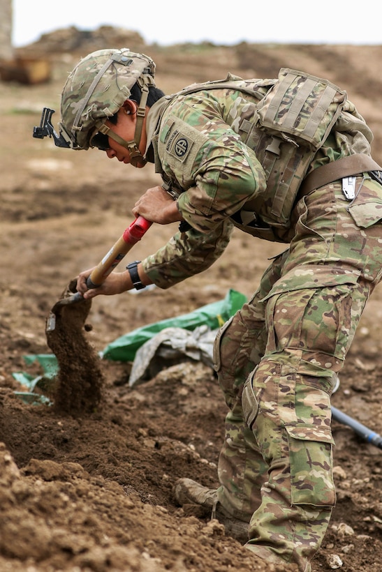 Army Pfc. Benjamin Richmond digs a mortar pit before a fire mission supporting the Iraqi army's 9th Division near Tarab, Iraq, March 18, 2017. Richmond is a mortarman assigned to the 82nd Airborne Division’s 2nd Brigade Combat Team, Combined Joint Task Force Operation Inherent Resolve. Army photo by Staff Sgt. Jason Hull