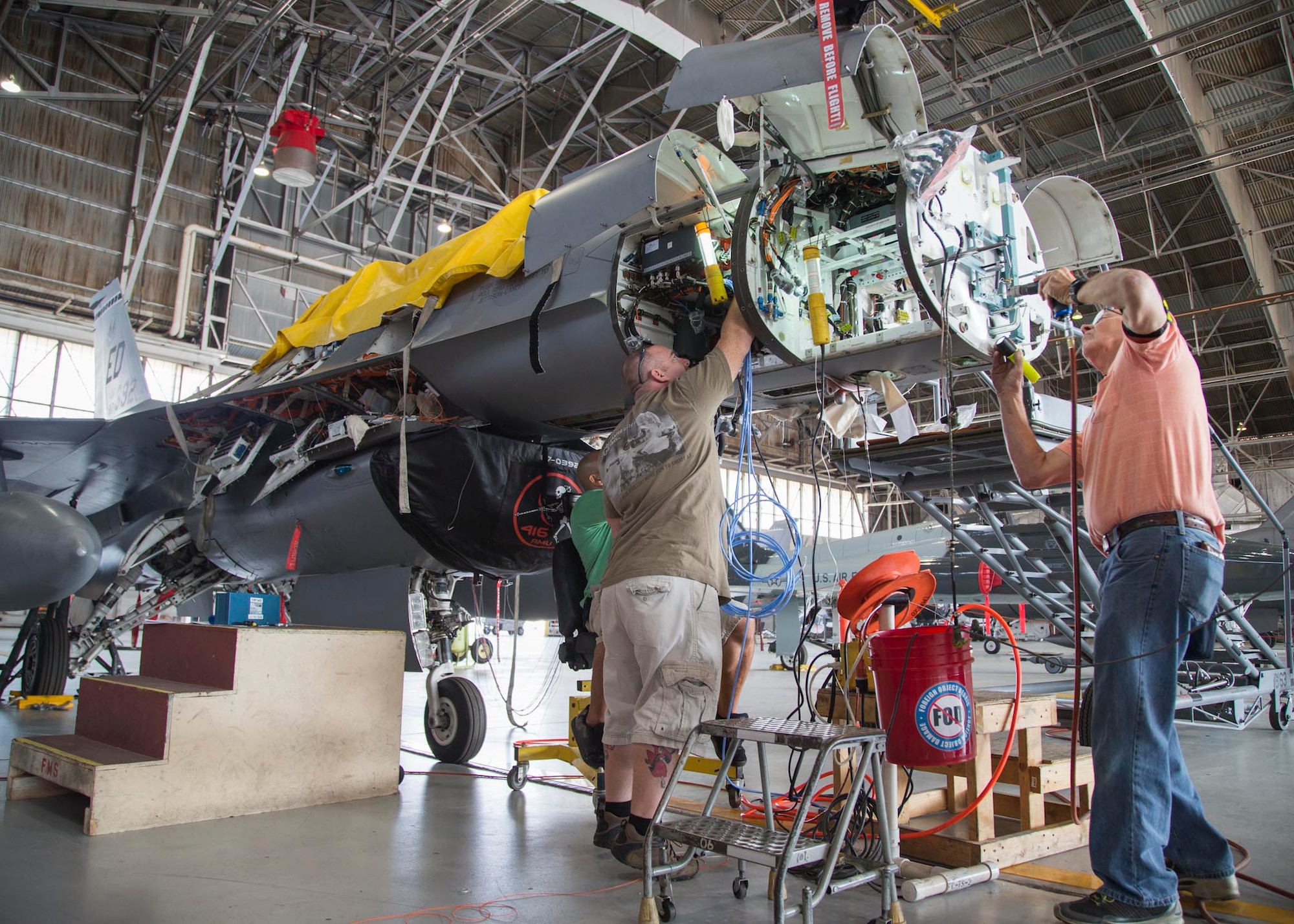 Maintenance personnel install mounting hardware for an APG-83 Scalable Agile Beam Radar on a 416th Flight Test Squadron F-16 Fighting Falcon in August 2015. The 416th FLTS has been conducting developmental testing on the fifth-generation Active Electronically Scanned Array fire control radar. (U.S. Air Force photo by Christopher Okula)