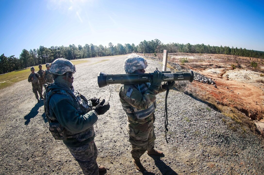 An Army range safety officer inserts a training round onto a practice M136 AT4 rocket launcher during a training exercise at Fort Bragg, N.C., March 17, 2017. Army photo by Capt. Adan Cazarez