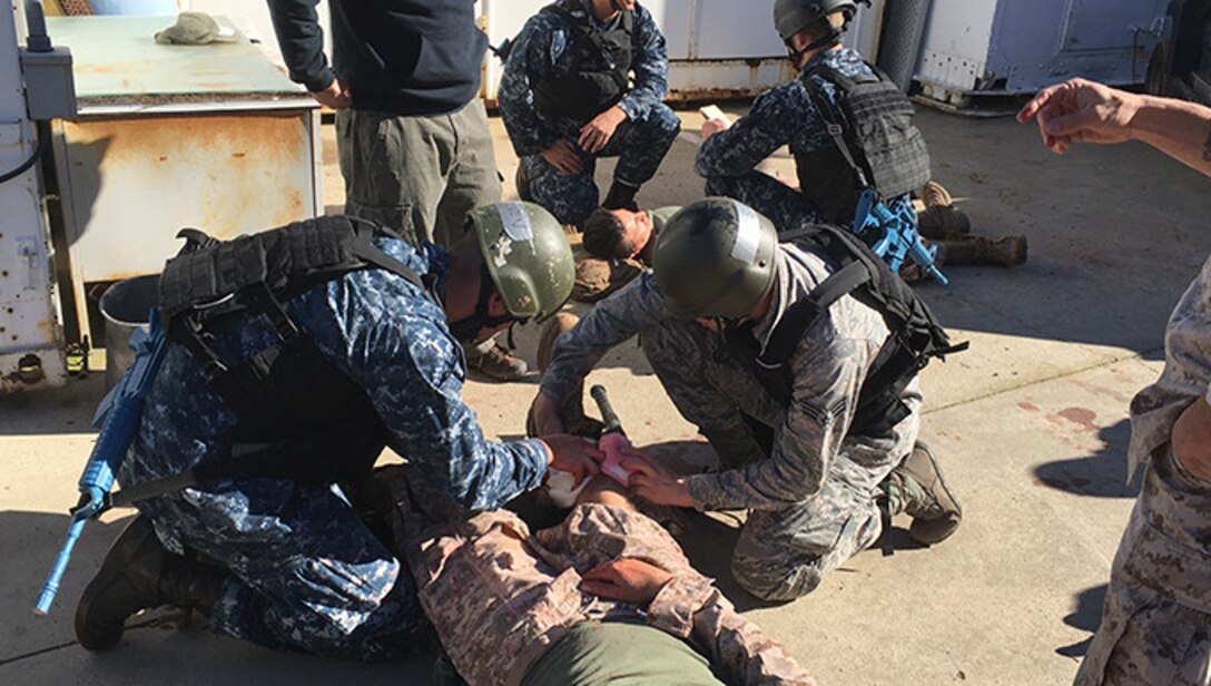 Members from the 446th Aerospace Medicine Squadron take part in a combat trauma course that simulated hyper-realistic conditions to fully engage participants in a war zone environment. The course covers treatment for injuries that may occur from combat trauma such as improvised explosive device blast injuries, airway closures or blockages, large abdominal injuries and also medical evacuation training. (Courtesy Photo U.S. Navy)