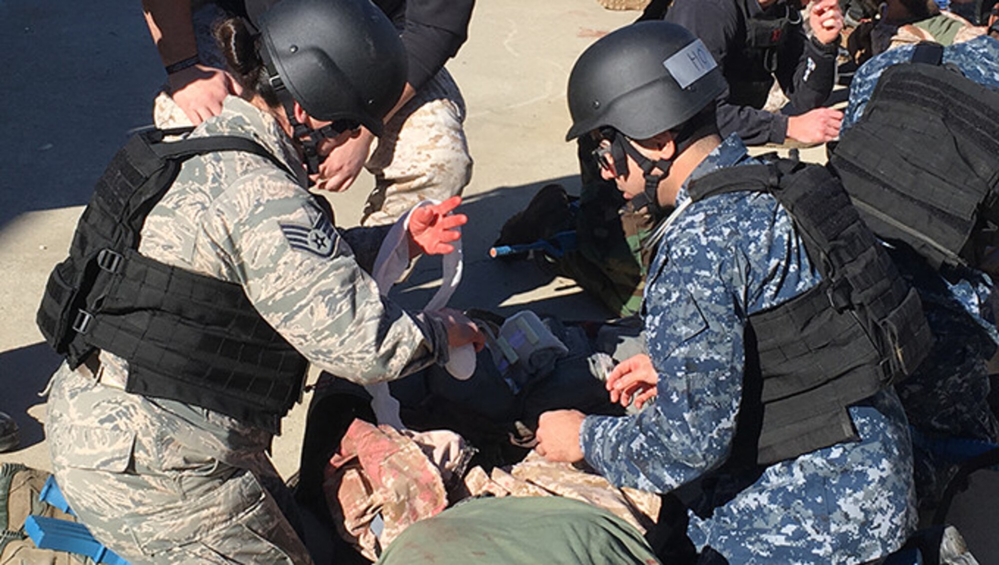 Members from the 446th Aerospace Medicine Squadron take part in a combat trauma course that simulated hyper-realistic conditions to fully engage participants in a war zone environment. The course covers treatment for injuries that may occur from combat trauma such as improvised explosive device blast injuries, airway closures or blockages, large abdominal injuries and also medical evacuation training. (Courtesy Photo U.S. Navy)
