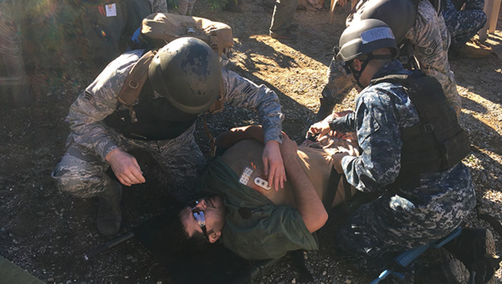 Members from the 446th Aerospace Medicine Squadron take part in a combat trauma course that simulated hyper-realistic conditions to fully engage participants in a war zone environment. The course covers treatment for injuries that may occur from combat trauma such as improvised explosive device blast injuries, airway closures or blockages, large abdominal injuries and also medical evacuation training. (Courtesy Photo U.S. Navy)