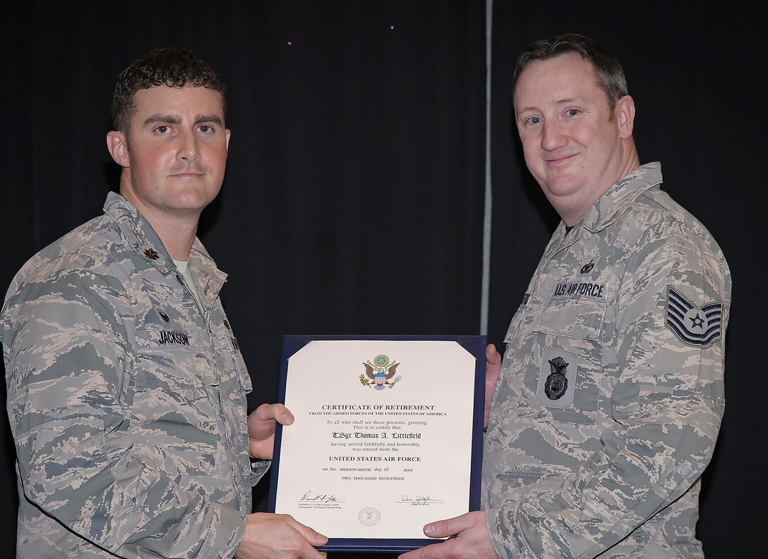 Tech. Sgt. Thomas Littlefield, right, receives his certificate of Air Force retirement from Maj. Christopher Jackson, the 71st Security Forces Squadron commander, during a ceremony held March 17 at Vance Air Force Base, Oklahoma. (U.S. Air Force photo/ David Poe)