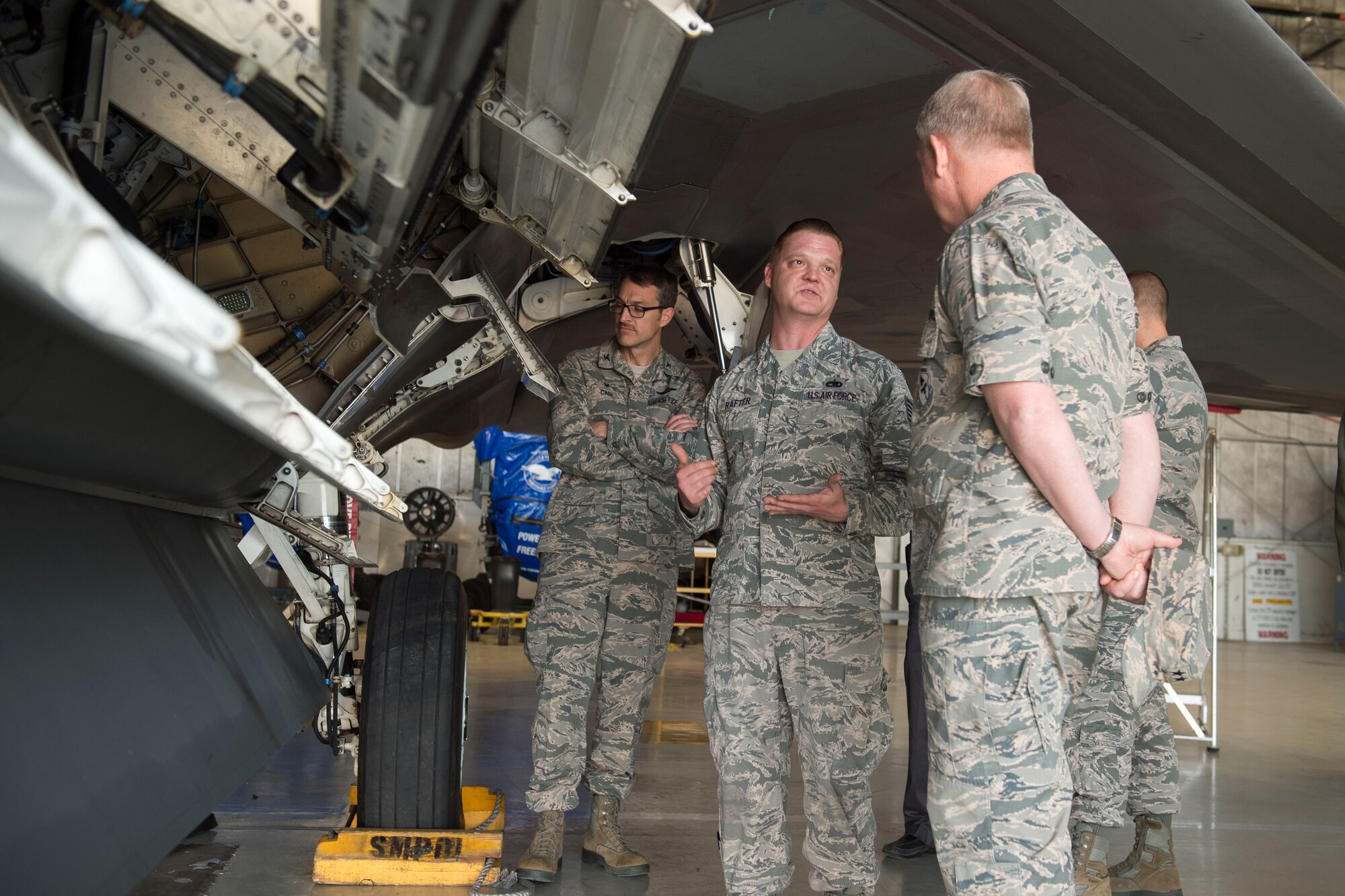 Maj. Gen. David Harris, Air Force Test Center commander, meeting with 411th Flight Test Squadron personnel, while touring the recently moved F-22 compound. (U.S. Air Force photo by Ethan Wagner)