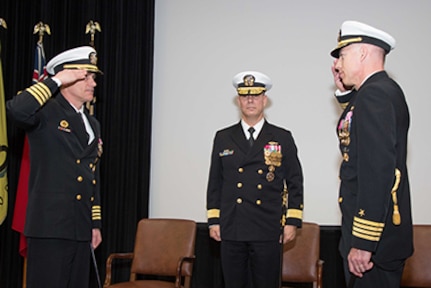 Capt. Michael Coughlin (left) reports to Rear Adm. Moises DelToro (center), commander of the Naval Undersea Warfare Center, NUWC Newport's parent command, that he has relieved  Capt. Geoffrey deBeauclair (right) as commanding officer, NUWC Division Newport, in a ceremony on March 17.  