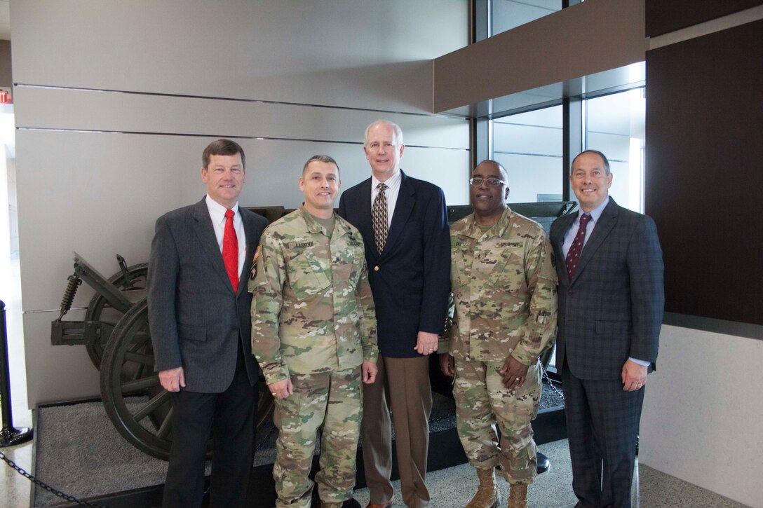 Maj. Gen. Lynn Collyar, Army Brig. Gen. John S. Laskodi, retired Army Maj. Gen. Michael Lally, Army Brig. Gen. Richard Dix, and retired Marine Maj. Gen. Peter Talleri in front of the circa 1905 U.S. Army Studebaker Utility Wagon, currently on loan from the U.S. Army Center of Military History as a featured display in the lobby of the new DLA Distribution headquarters. 