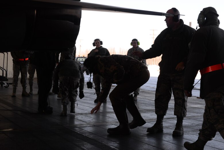 U.S. Air Force Airmen duck beneath the exhaust of an F-16 Fighting Falcon aircraft March 21, 2017, at Eielson Air Force Base, Alaska. The Airmen were part of the inaugural 354th Fighter Wing Shadow Program, a program designed to teach Airmen about different operations on base. (U.S. Air Force photo by Airman Eric M. Fisher)