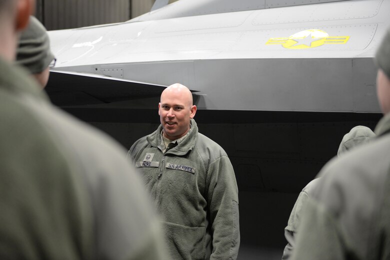 U.S. Air Force Master Sgt. Ian Neske, an 354th Aircraft Maintenance Squadron specialist section chief, explains the function of an F-16 Fighting Falcon aircraft part March 21, 2017, at Eielson Air Force Base, Alaska. Neske was one of the subject matter experts during the job shadow, as part of the 354th Fighter Wing Shadow Program. (U.S. Air Force photo by Airman Eric M. Fisher)