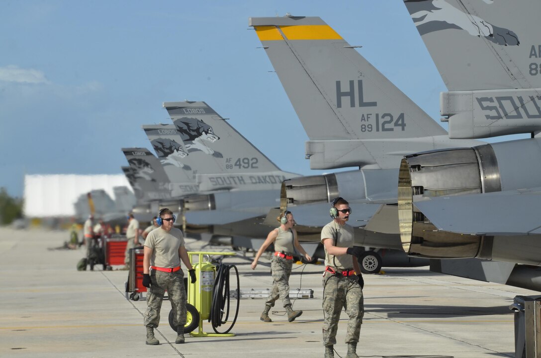 114th Aircraft Maintenance weapon loaders mount a training missile on a F-16C during a training mission March 14, 2017, Naval Air Station Key West, FL. The purpose of the deployment was to train with the U.S. Navy and Canadian Air Force. This training serves as the culmination of the 175th Fighter Squadron air-to-air training. (U.S. Air National Guard photo by Maj. Travis Schuring/Released)