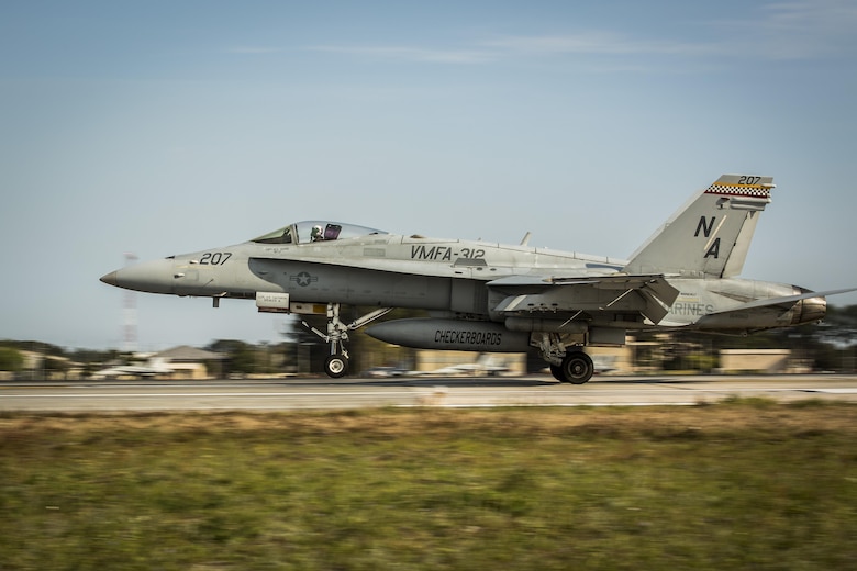 An F/A-18C Hornet aircraft takes off during a field carrier landing practice aboard Marine Corps Air Station Beaufort, March 22. This FCLP was conducted in preparation for an upcoming exercise aboard the USS Theodore Roosevelt, a naval aircraft carrier, scheduled for April. The pilot and the aircraft are with VMFA-312, Marine Aircraft Group 31.