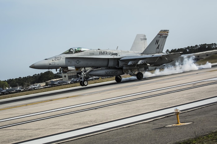 An F/A-18C Hornet aircraft conducts a simulated aircraft carrier landing aboard Marine Corps Air Station Beaufort, March 22. The
runway is equipped with a painted outline simulating the carrier for the pilots. The Marine and aircraft are with Marine Fighter Attack Squadron 312, Marine Aircraft Group 31.