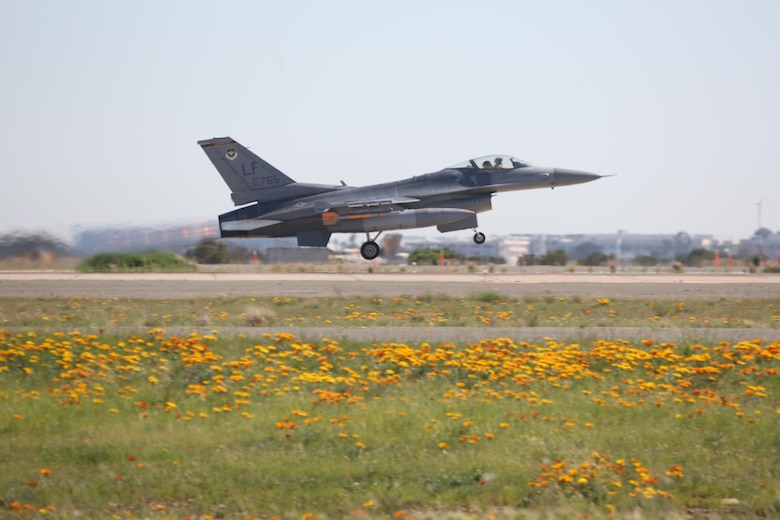 An F-16 Falcon with the Air Forces 310th Fighter Squadron takes off en route to a simulated dog fight against F/A-18 Hornets with Marine Fighter Attack Squadron (VMFA) 314 at Marine Corps Air Station Miramar, Calif., March 16. The two squadrons are training their pilots in basic fighting maneuvers from March 16 to March 24 at MCAS Miramar.