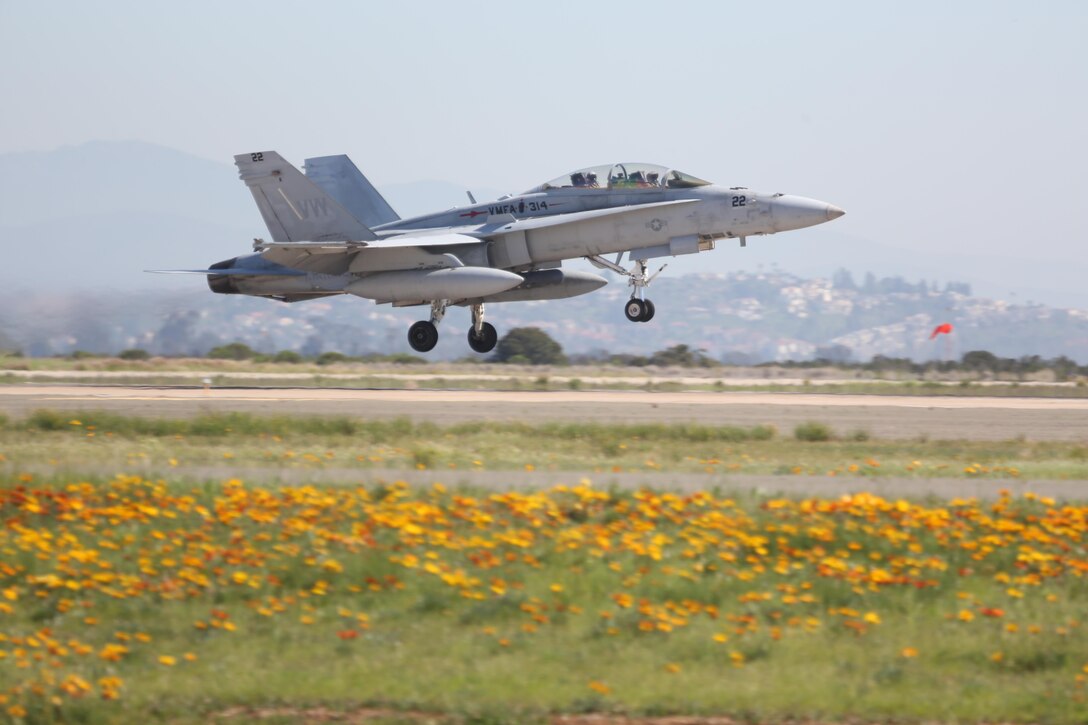 An F/A-18 Hornet with Marine Fighter Attack Squadron (VMFA) 314 takes off en route to a simulated dog fight against the Air Force’s F-16 Falcons with the 310th Fighter Squadron at Marine Corps Air Station Miramar, Calif., March 16. The two squadrons are training their pilots in basic fighting maneuvers from March 16 to March 24 at MCAS Miramar.
