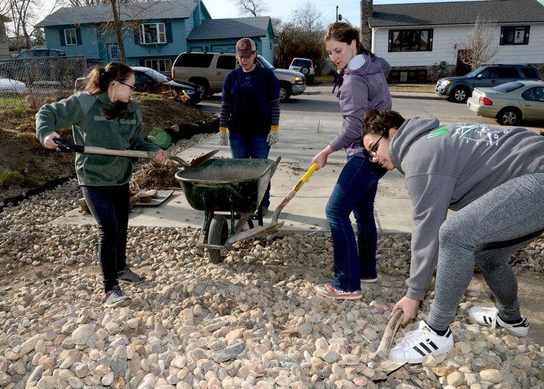 A team of women from Ellsworth Air Force Base work on a home’s rock landscape during a Habitat for Humanity home build in Rapid City, S.D., March 18, 2017, as part of Women’s History Month. This was the first time the Black Hills area Habitat for Humanity branch has had an all-women’s team for WHM. (U.S. Air Force photo by Airman 1st Class Donald C. Knechtel)