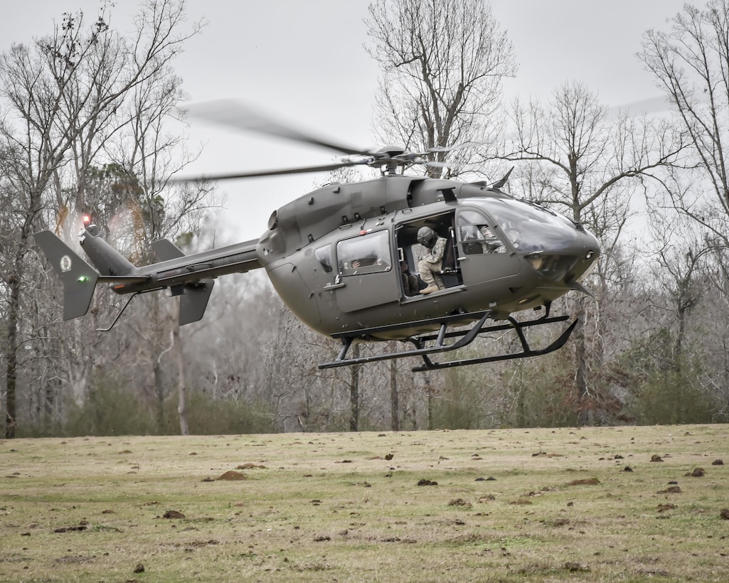 Aircrew from the 117th Air Refuelling Wing exit an Alabama Army National Guard helicopter during survival training in Hanceville, Alabama February 12, 2017. (U.S. Air National Guard photo by: Senior Master Sgt. Ken Johnson)