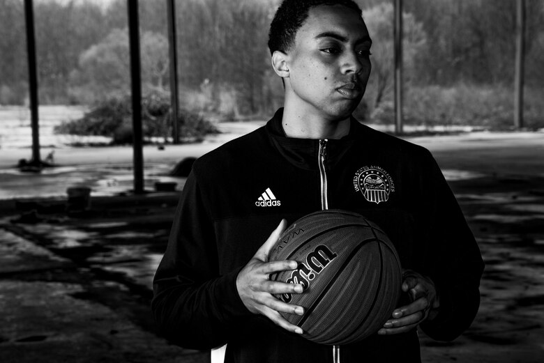 Senior Airman Anthony Morris holds a basketball in an abandoned building outside of Maxwell Air Force Base, Feb. 17. Before joining the Air Force and playing on the Armed Forces basketball team, Morris overcame humble begginings to play college basketball. (U.S. Air Force photo by Senior Airman William Blankenship)