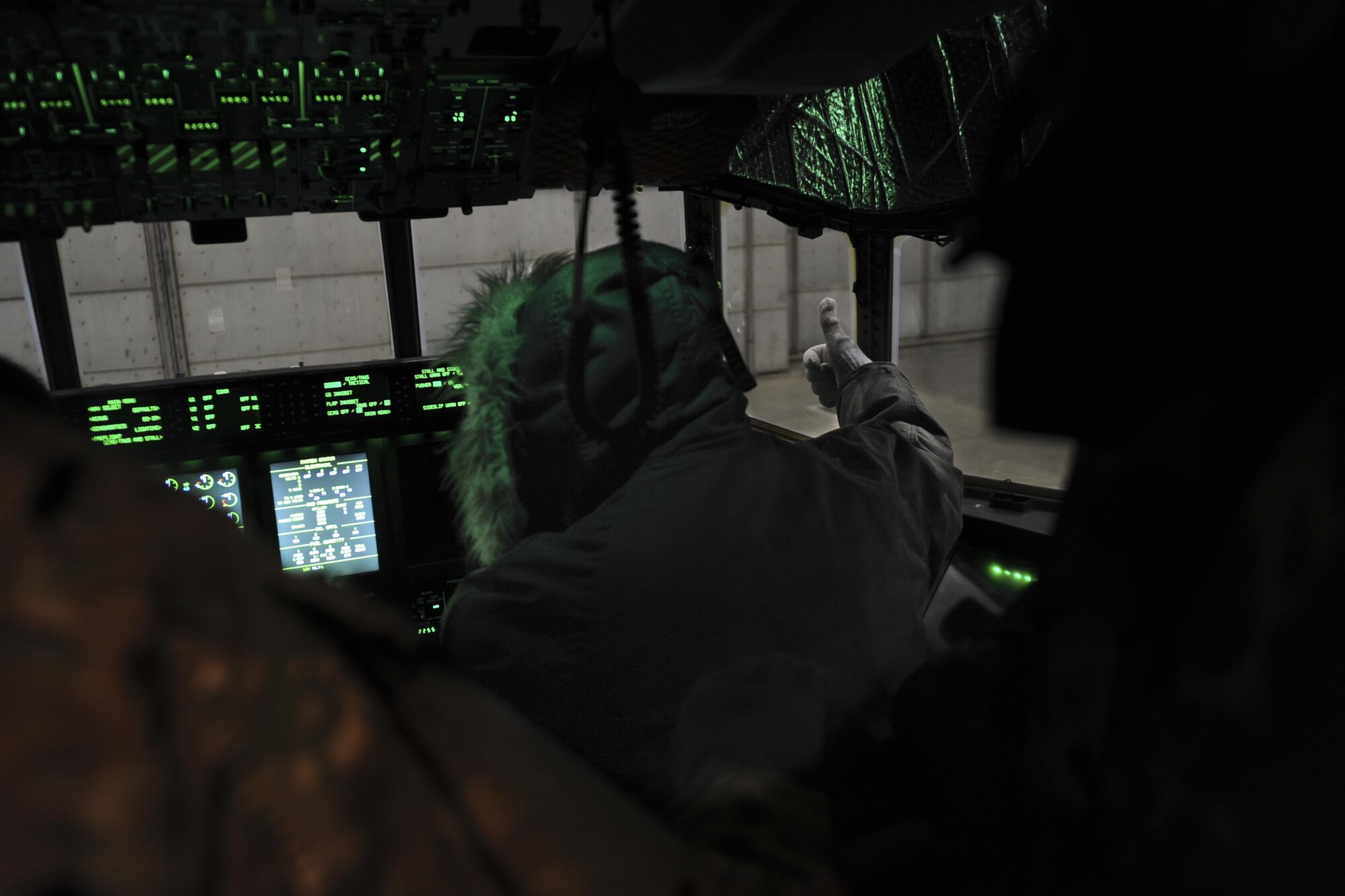 Christopher Williams, an electrician with the 1st Special Operations Aircraft Maintenance Squadron, gives a team mate a thumbs up at Eglin Air Force Base, March 21, 2017. The AC-130J Ghostrider gunship underwent it's first cold soak, a test done to examine the aircraft's ability to function in frigid conditions. The gunship was brought to zero-degree temperatures. (U.S. Air Force photo by Airman 1st Class Dennis Spain)