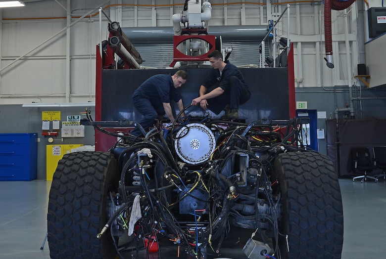 Senior Airman William Schlee (left), 627th Logistic Readiness Squadron material handling equipment mechanic and Airman 1st Class Justyn Zangwill (right), 627th LRS fire truck and refuel maintenance journeyman, detangle hoses on a McChord Field fire truck, March 21, 2017 at Joint Base Lewis-McChord, Wash. The fire truck was having mechanical issues and Schlee and Zangwill were able to identify the issue and fix it for $2,000 instead of contracting it out for an estimated cost of $70,000. (U.S. Air Force photo/Senior Airman Divine Cox)