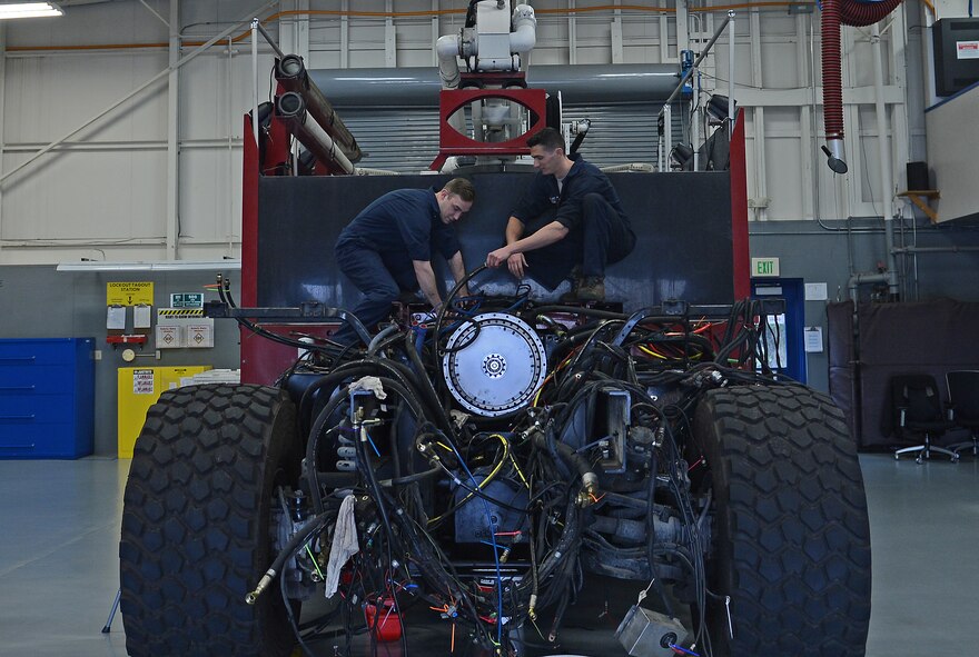 Senior Airman William Schlee (left), 627th Logistic Readiness Squadron material handling equipment mechanic and Airman 1st Class Justyn Zangwill (right), 627th LRS fire truck and refuel maintenance journeyman, detangle hoses on a McChord Field fire truck, March 21, 2017 at Joint Base Lewis-McChord, Wash. The fire truck was having mechanical issues and Schlee and Zangwill were able to identify the issue and fix it for $2,000 instead of contracting it out for an estimated cost of $70,000. (U.S. Air Force photo/Senior Airman Divine Cox)