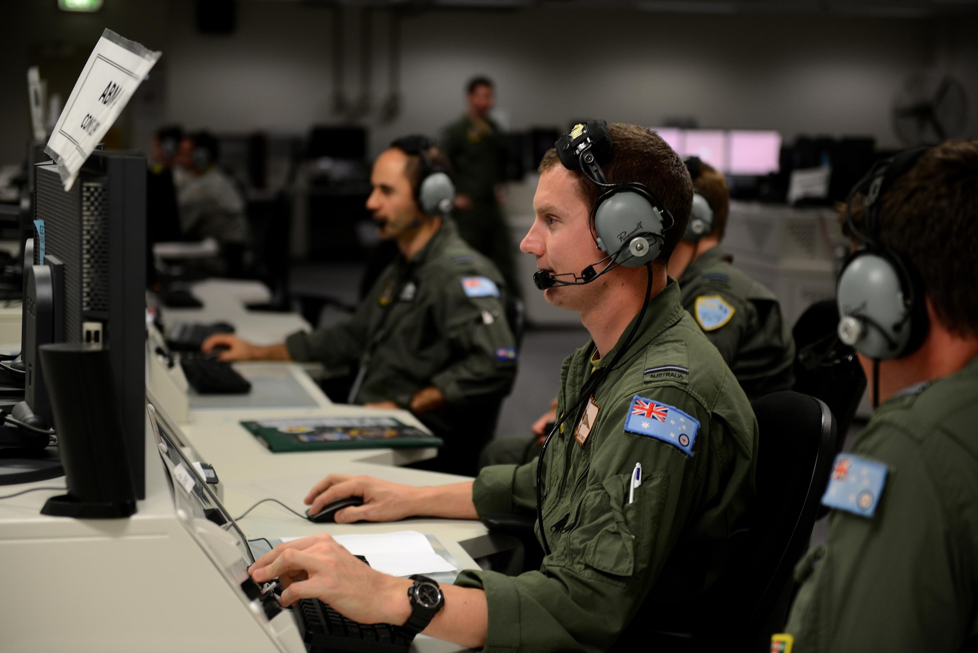 Royal Australian Air Force Flying Officer “Wally”, 41 Wing Surveillance and Control Training Unit air battle manager, debriefs with his counterpart in the Tactical Control Center, on RAAF Base Williamtown, New South Wales, Australia, March 23, 2017. Throughout the duration of the exercise, air battle managers are primarily responsible for command and control of the RAAF ‘Blue Air’ forces and for overseeing battle management operations when scenarios are active. (U.S. Air Force photo by Tech. Sgt. Steven R. Doty)