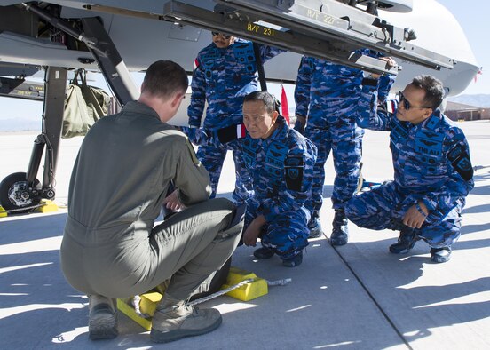 Lt. Col. Timothy Monroe, the 9th Attack Squadron commander, explains RPA operations to Maj. Gen. Dedy Permadi, an Indonesian Air Force officer, during a distinguished visitor tour at Holloman Air Force Base, N.M. on March 15, 2017. The IDAF delegation visited several sites, including the Operations Group, the MQ-9 Flight Training Unit and the 16th Training Squadron, where they were able to view a remotely piloted aircraft and learn more about Holloman’s RPA mission. (U.S. Air Force photo by Airman 1st Class Alexis P. Docherty)