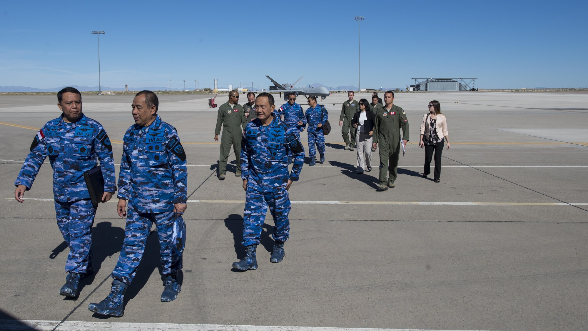 Members of the Indonesian Air Force exit the MQ-9 Training Unit’s flight line following a distinguished visitor tour at Holloman Air Force Base, N.M. on March 15, 2017. IDAF delegation members were bussed to the 16th Training Squadron, where delegation members were able to handle an RPA flight simulator, and learn more about Holloman’s RPA training units. (U.S. Air Force photo by Airman 1st Class Alexis P. Docherty)