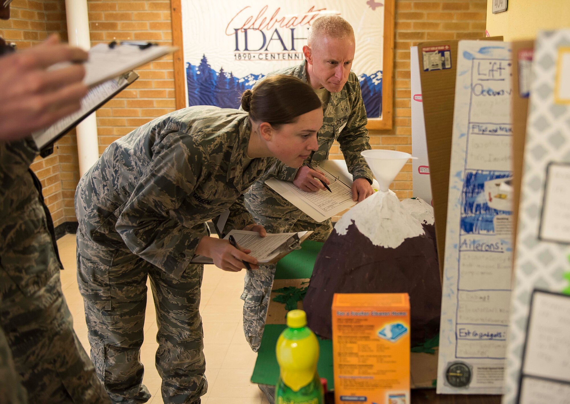 Judges, assigned to various sections across Mountain Home Air Force Base, Idaho critique a science fair volcano at Stephensen Elementary School,March 23, 2017. These volunteers judged the kindergarten through fourth grade students' projects in more than 10 areas to include hypothesis, application of the project and the students conclusion of their findings. (U.S. Air Force photo by Senior Airman Connor J. Marth/Released)