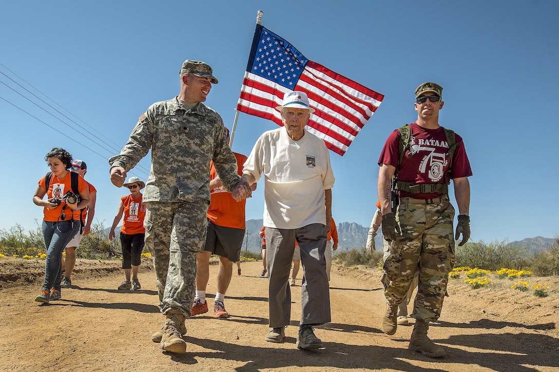Retired Army Col. Ben Skardon, 99, a survivor of the Bataan Death March, walks in the annual Bataan Memorial Death March with two Army medics at White Sands Missile Range, N.M., March 19, 2017. This was the 10th time Skardon walked in the event. Army Reserve photo by Staff Sgt. Ken Scar
