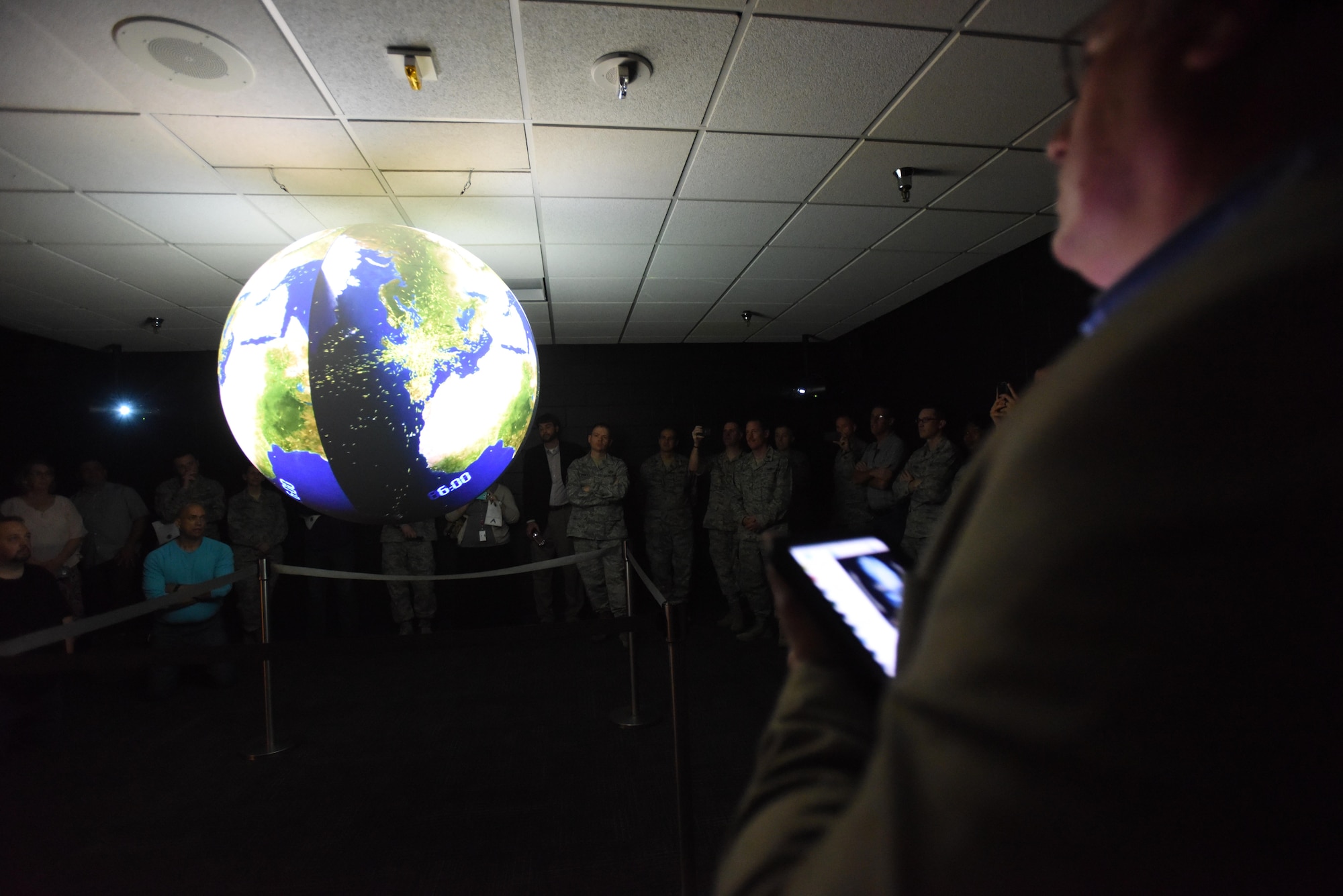 Keesler personnel watch a Science on a Sphere demonstration during a ribbon cutting ceremony at the Weather Training Complex March 23, 2017, on Keesler Air Force Base, Miss. This latest training aid displays planetary data onto a suspended carbon-fiber sphere helping instructors enhance student’s understanding of the atmosphere. (U.S. Air Force photo by Kemberly Groue)