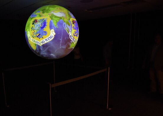 A Science on a Sphere hangs inside a 335th Training Squadron weather training room during a ribbon cutting ceremony at the Weather Training Complex March 23, 2017, on Keesler Air Force Base, Miss. This latest training aid displays planetary data onto a suspended carbon-fiber sphere helping instructors enhance student’s understanding of the atmosphere. (U.S. Air Force photo by Kemberly Groue)