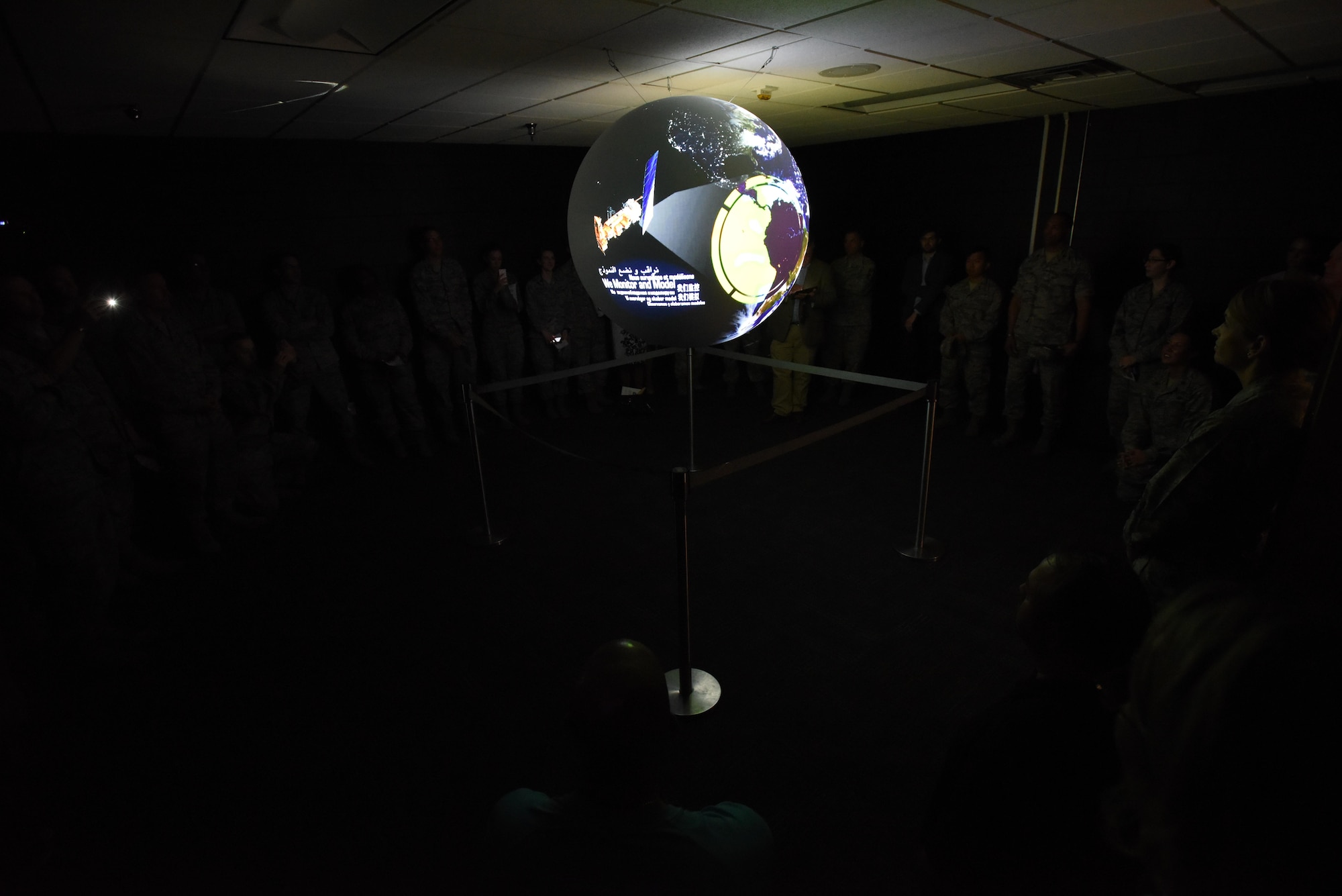Keesler personnel receive a Science on a Sphere demonstration during a ribbon cutting ceremony at the Weather Training Complex March 23, 2017, on Keesler Air Force Base, Miss. This latest training aid displays planetary data onto a suspended carbon-fiber sphere helping instructors enhance student’s understanding of the atmosphere. (U.S. Air Force photo by Kemberly Groue)