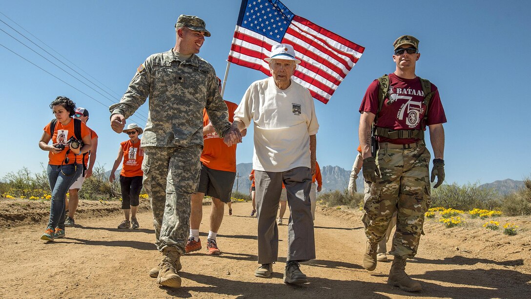 Retired Army Col. Ben Skardon, 99, a survivor of the Bataan Death March, walks in the annual Bataan Memorial Death March with two Army medics at White Sands Missile Range, N.M., March 19, 2017. This was the 10th time Skardon walked in the event. Army Reserve photo by Staff Sgt. Ken Scar