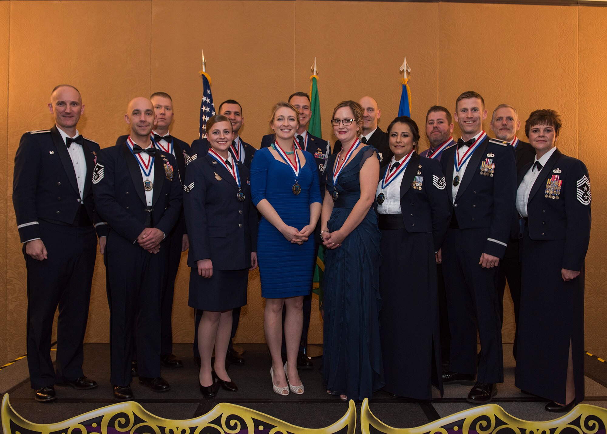 The winners of the 92nd Air Refueling Wing 2016 Annual Awards stand for a group photo with Col. Ryan Samuelson (left), 92nd ARW commander, and CMSgt. Shannon Rix, 92nd ARW command chief master sergeant, at a ceremony held in downtown Spokane March 17, 2017. The winners will go on to compete at an Air Mobility Command level.