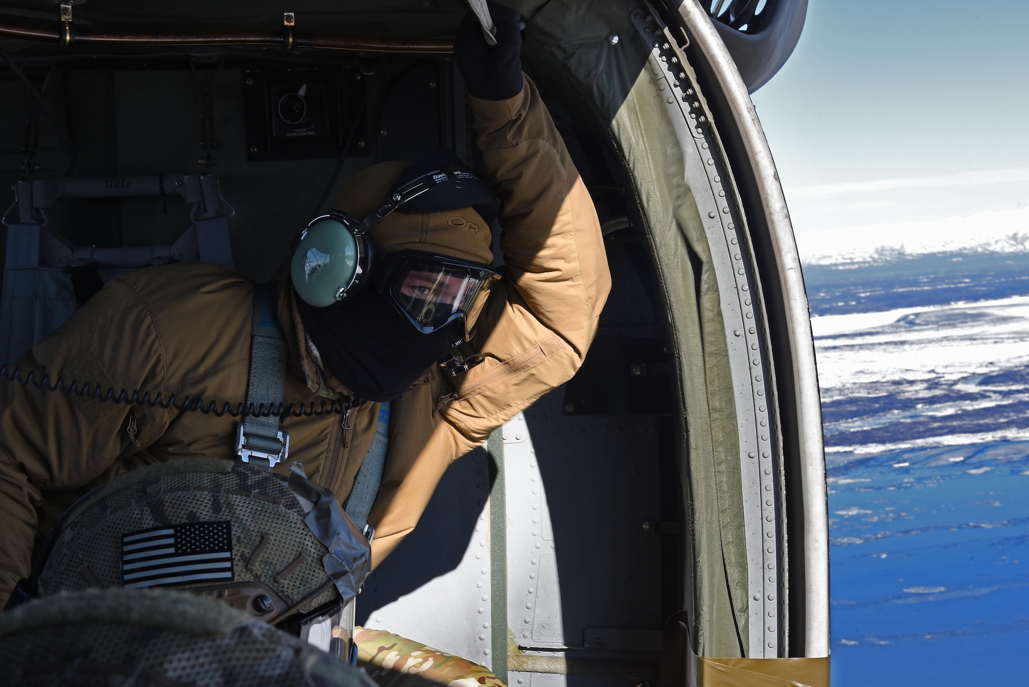 Senior Airman Trenten Collins, 3rd Air Support Operations Squadron tactical air control party member, looks out of a UH-60 Black Hawk during jump training at the Malemute Drop Zone at Joint Base Elmendorf-Richardson, Alaska, March 22, 2017. Routine jump training is conducted to maintain proficiency and train for prospective missions. 