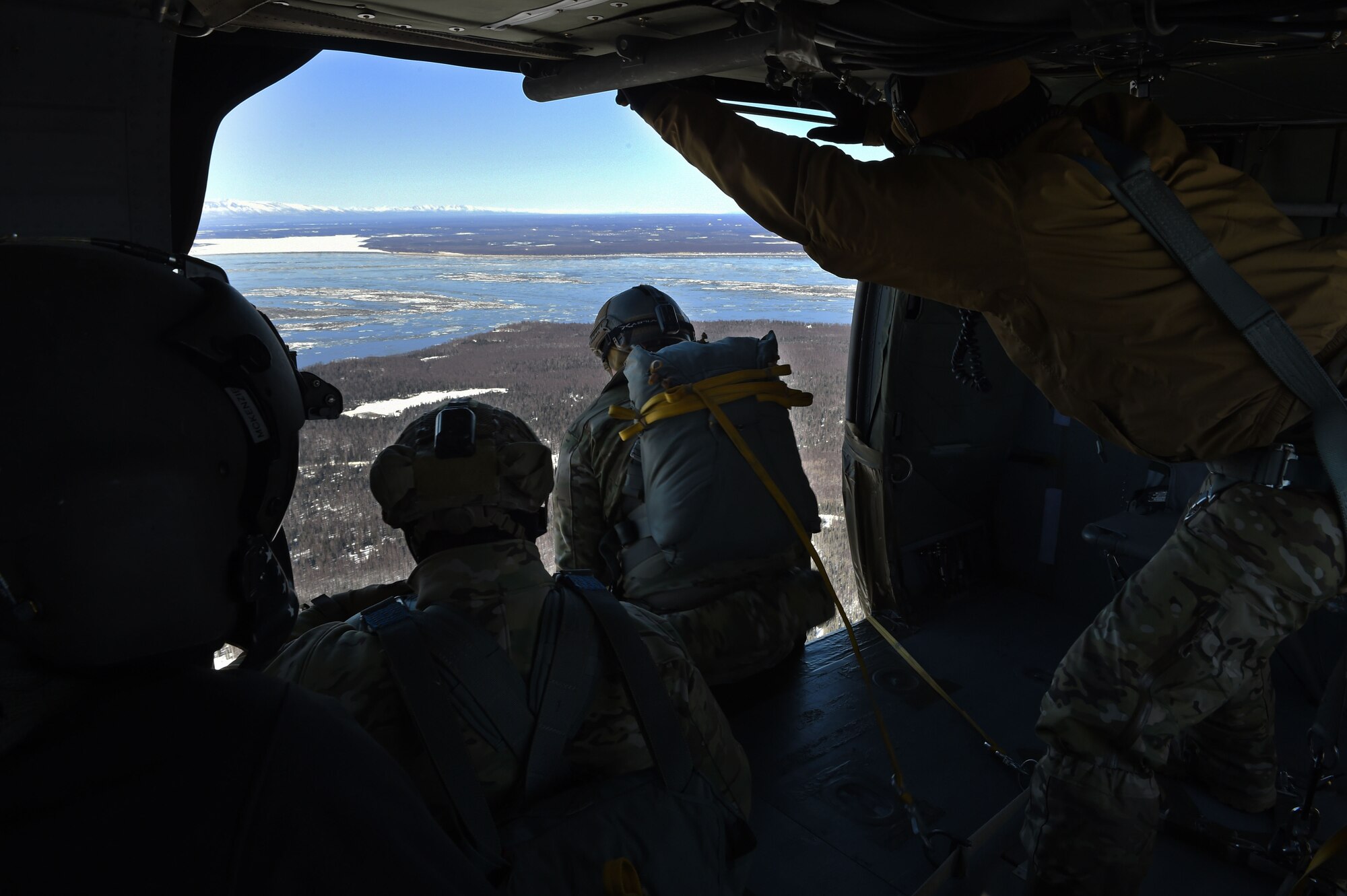 A tactical air control party Airman with the 3rd Air Support Operations Squadron, jumps out of a UH-60 Black Hawk during jump training at the Malemute Drop Zone at Joint Base Elmendorf-Richardson, Alaska, March 22, 2017. Routine jump training is conducted to maintain proficiency and train for prospective missions. 