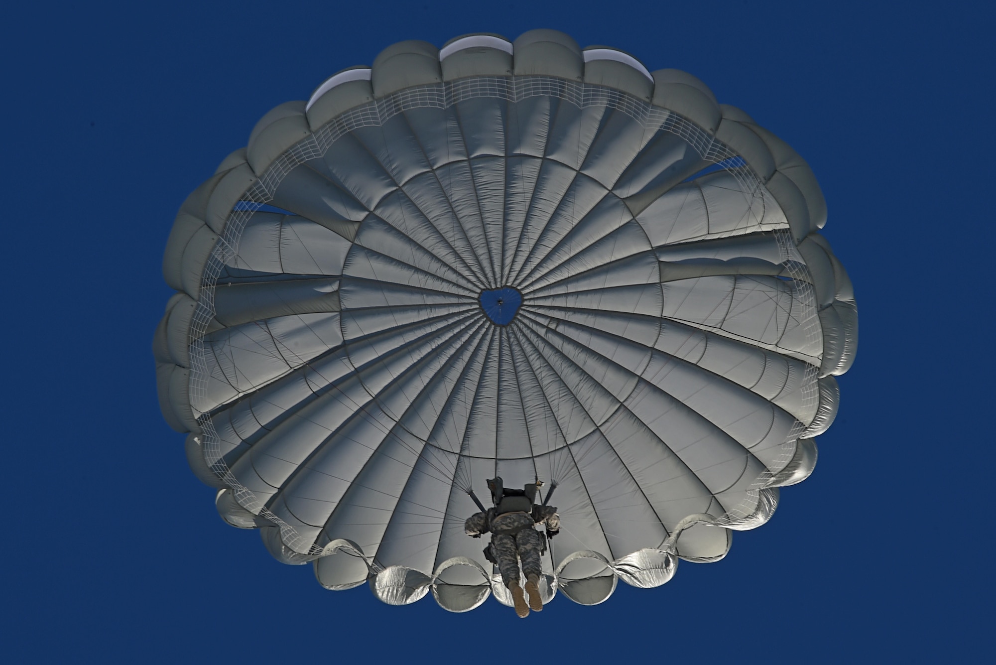 A paratrooper with the 4th Quartermaster Company, 725th Brigade Support Battalion (Airborne), 4th Infantry Brigade Combat Team (Airborne), 25th Infantry Division, U.S. Army Alaska, prepares to land during jump training at the Malemute Drop Zone at Joint Base Elmendorf-Richardson, Alaska, March 22, 2017. Routine jump training is conducted to maintain proficiency and train for prospective missions. 