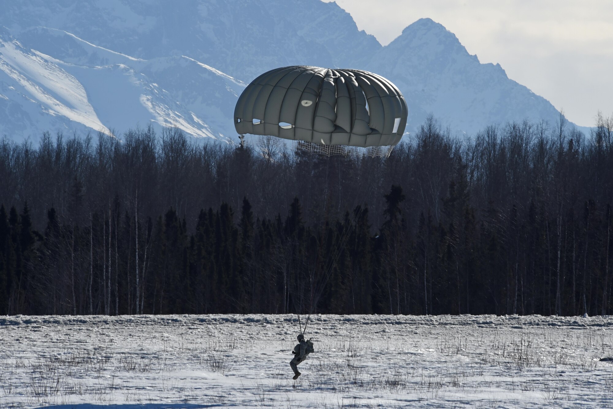 A paratrooper with the 4th Quartermaster Company, 725th Brigade Support Battalion (Airborne), 4th Infantry Brigade Combat Team (Airborne), 25th Infantry Division, U.S. Army Alaska, prepares to land during jump training at the Malemute Drop Zone at Joint Base Elmendorf-Richardson, Alaska, March 22, 2017. Routine jump training is conducted to maintain proficiency and train for prospective missions. 