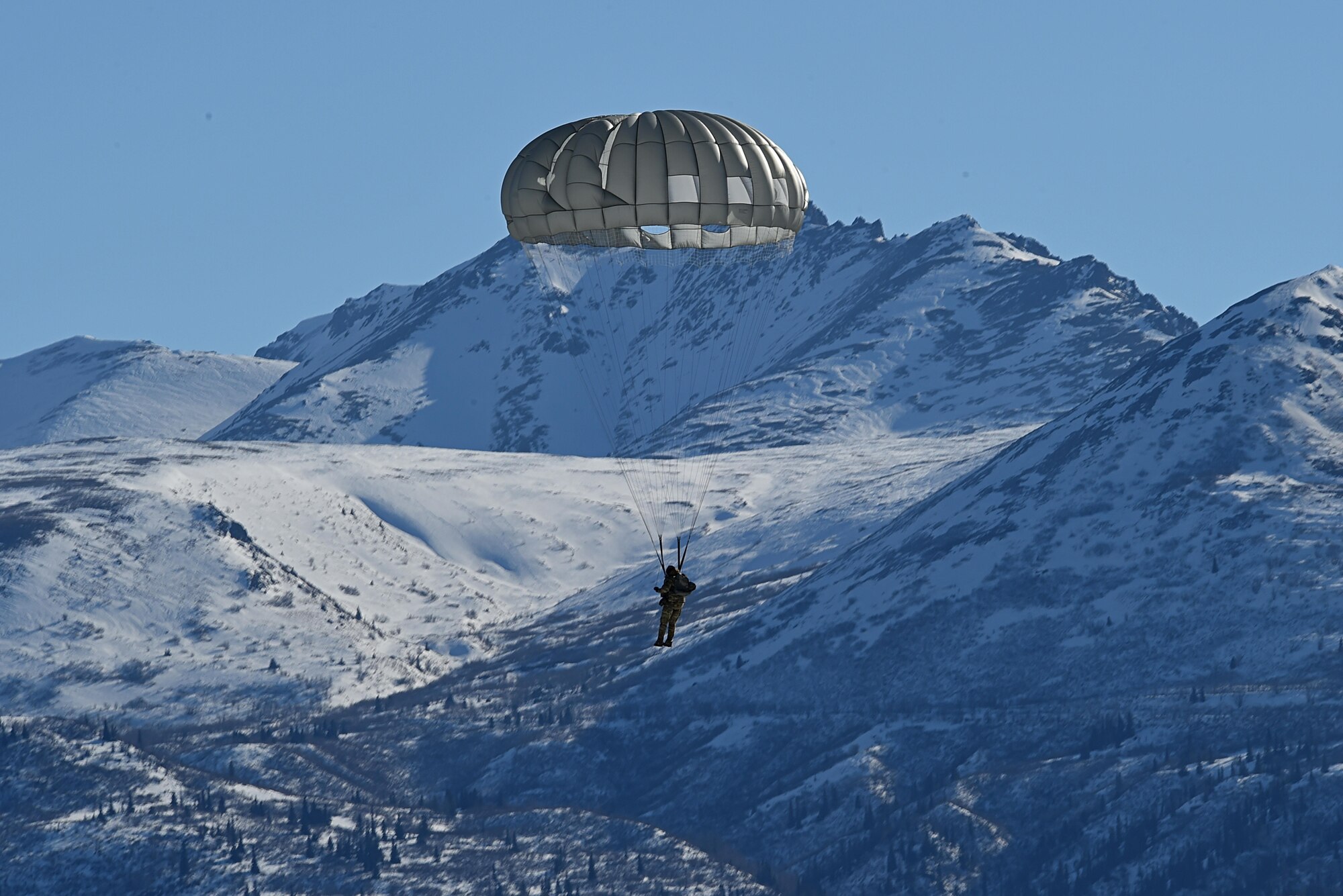 A tactical air control party Airman with the 3rd Air Support Operations Squadron, prepares to land at the Malemute Drop Zone during jump training at Joint Base Elmendorf-Richardson, Alaska, March 22, 2017. Routine jump training is conducted to maintain proficiency and train for prospective missions. 