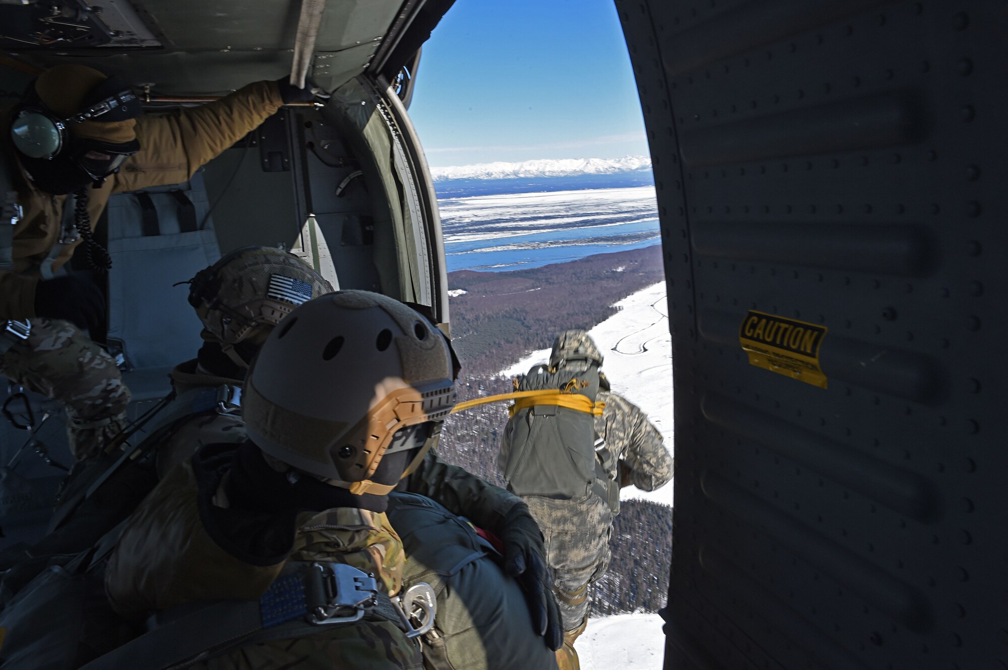 A paratrooper with the 4th Quartermaster Company, 725th Brigade Support Battalion (Airborne), 4th Infantry Brigade Combat Team (Airborne), 25th Infantry Division, U.S. Army Alaska,  jumps out of a UH-60 Black Hawk during jump training at the Malemute Drop Zone at Joint Base Elmendorf-Richardson, Alaska, March 22, 2017. Routine jump training is conducted to maintain proficiency and train for prospective missions. 