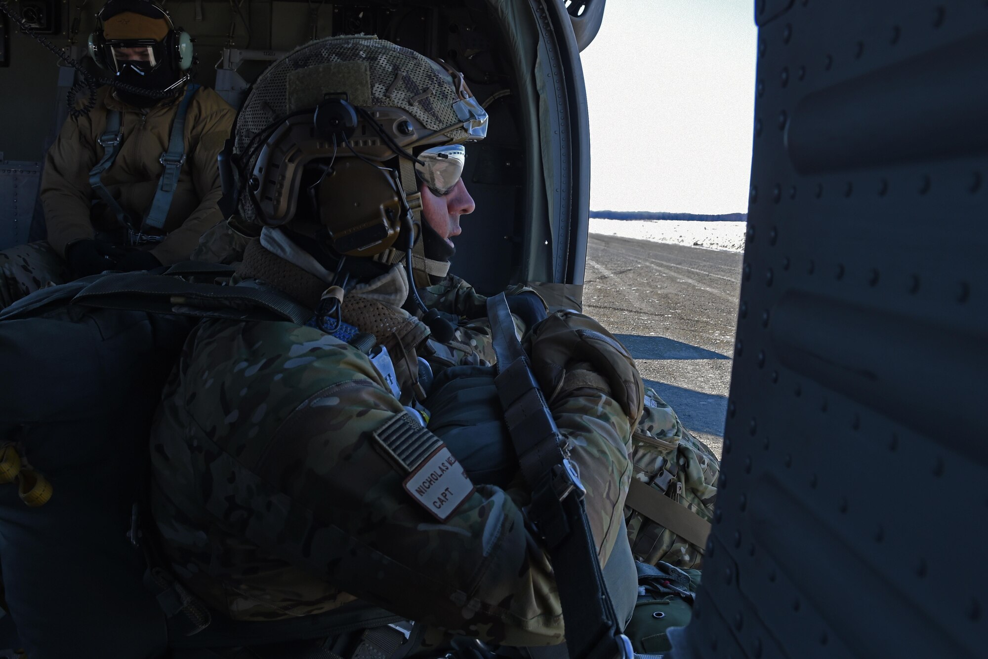 Air Force Capt. Nicholas Mello, 3rd Air Support Operations Squadron tactical air control party member, looks out of a UH-60 Black Hawk during jump training at the Malemute Drop Zone at Joint Base Elmendorf-Richardson, Alaska, March 22, 2017. Routine jump training is conducted to maintain proficiency and train for prospective missions. 