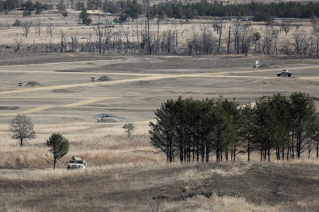 Army Reserve Soldiers assigned to the 822nd Movement Control Team, Brockton, Massachusetts, left vehicle, drive through their firing lane to engage stationary targets on a blank fire range while separate Army Reserve Soldiers, far right vehicle, engage targets on the Gunnery Table Six live-fire range during the Operation Cold Steel exercise conducted at Fort McCoy, Wisconsin, Mar. 22, 2017. Operation Cold Steel is the U.S. Army Reserve’s first large-scale live-fire training and crew-served weapons qualification and validation exercise taking place from March 9 through April 25, 2017. Cold Steel is key to ensuring that America’s Army Reserve units and Soldiers are trained and ready to deploy on short-notice and bring combat-ready and lethal firepower in support of the Total Army and Joint Force partners around the world. In support of the Total Army Force, First Army Master Gunners participated in Cold Steel to provide expertise in crew level gunnery qualifications, and to develop Vehicle Crew Evaluator training, preparing units here and when they return to their home stations to conduct crew served weapons training and vehicle crew gunnery at the unit-level. 475 crews with an estimated 1,600 Army Reserve Soldiers will certify in M2, M19 and M240 Bravo crew served weapons mounted to various military vehicle platforms such as Humvees, Family of Medium Tactical Vehicles, Heavy Expanded Mobility Tactical Trucks, and Heavy Equipment Transport Systems across 12-day rotations (15 crews per cycle) through the seven-week exercise.
(U.S. Army Reserve photo by Master Sgt. Anthony L. Taylor)