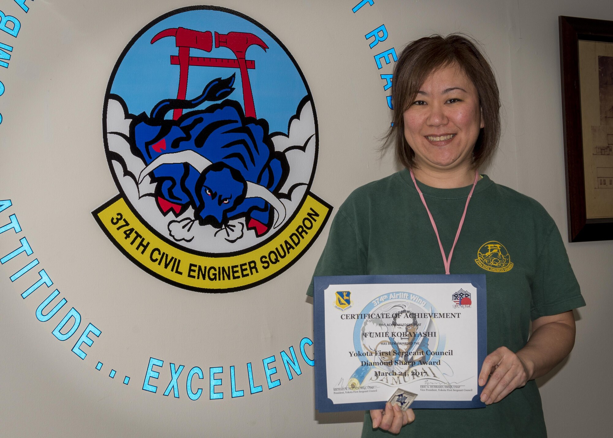 Fumie Kobayashi, 374th Civil Engineer Squadron force management chief, poses for a photo after winning the Diamond Sharp Award March 24, 2017, at Yokota Air Base, Japan. The Diamond Sharp Award is  used by the Yokota's First Sergeant Council to recognize those who have gone above and beyond in helping others.(U.S. Air Force photo by Airman 1st Class Juan Torres)