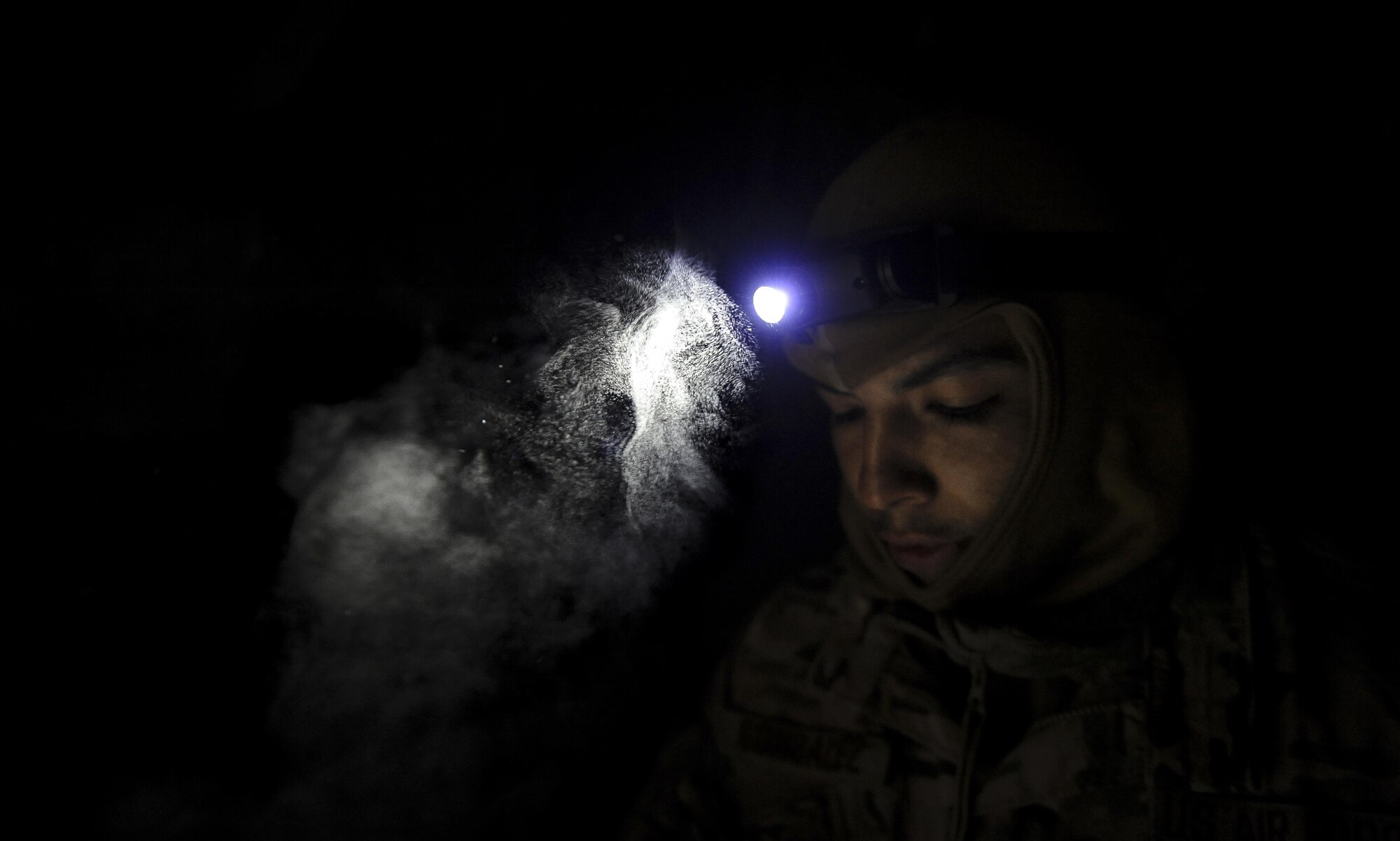 Senior Airman Adrian Gonzalez, a crew chief with the 1st Special Operations Aircraft Maintenance Squadron, looks at a step-by-step checklist at Eglin Air Force Base, March 21, 2017.  This checklist was used to bring power to the AC-130J Ghostrider gunship while it underwent it's first cold soak, a test done to examine the aircrafts operational competence in arctic temperatures. (U.S. Air Force photo by Airman 1st Class Dennis Spain)