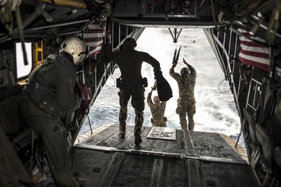 Marines jump from a CH-53E Super Stallion during an exercise in the Philippine Sea, March 19, 2017. The Marines, assigned to the Maritime Raid Force of the 31st Marine Expeditionary Unit, are embarked on the USS Bonhomme Richard. Navy photo by Seaman Apprentice Jesse Marquez Magallanes